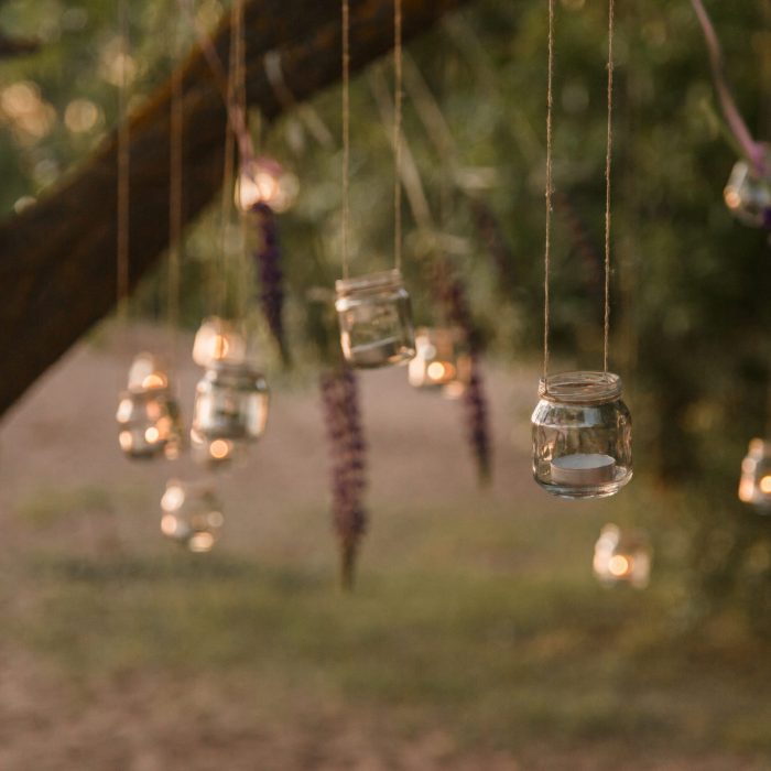 Mason jar candle hanging on tree for wedding decor