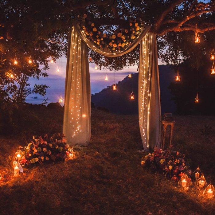 Night wedding ceremony with a lot of lights, candles, lanterns. Beautiful romantic shining decorations in twilight